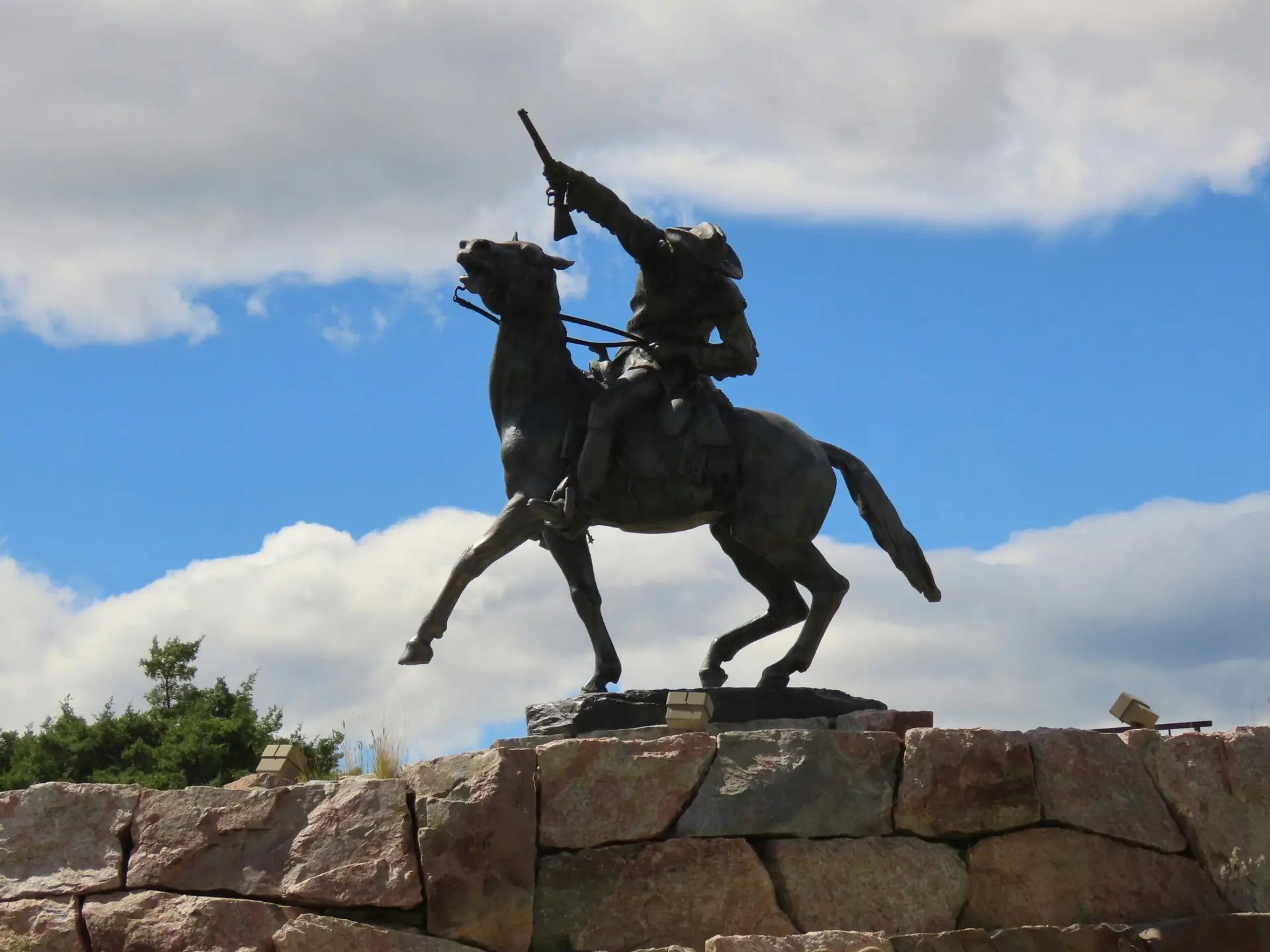 Bronze cowboy statue in Cody WY honoring the region’s Western heritage and ranching traditions under Wyoming skies