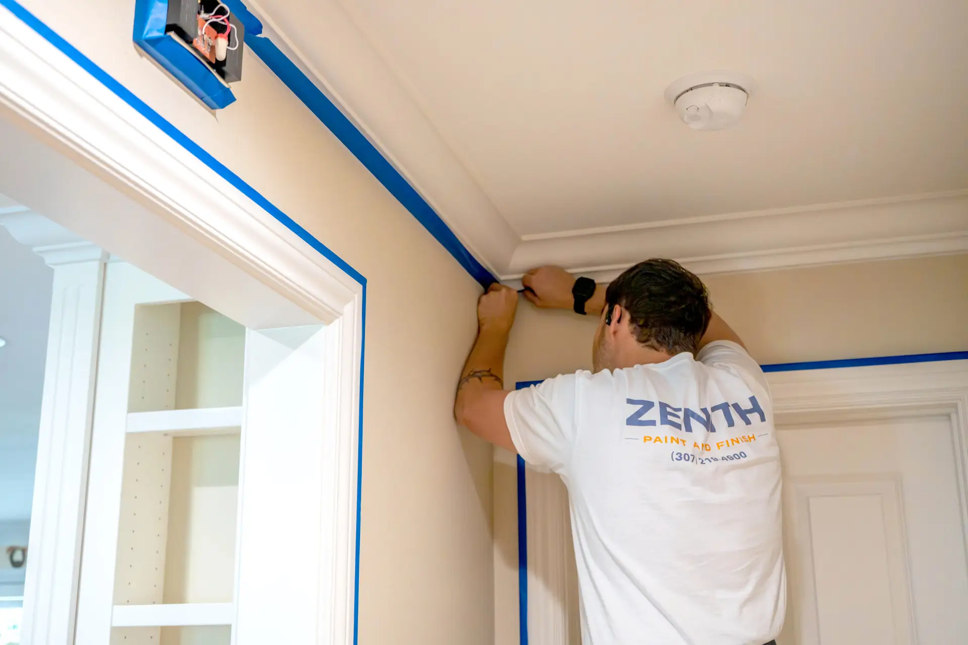 Careful crown molding prep before painting by the Zenith Paint and Finish crew