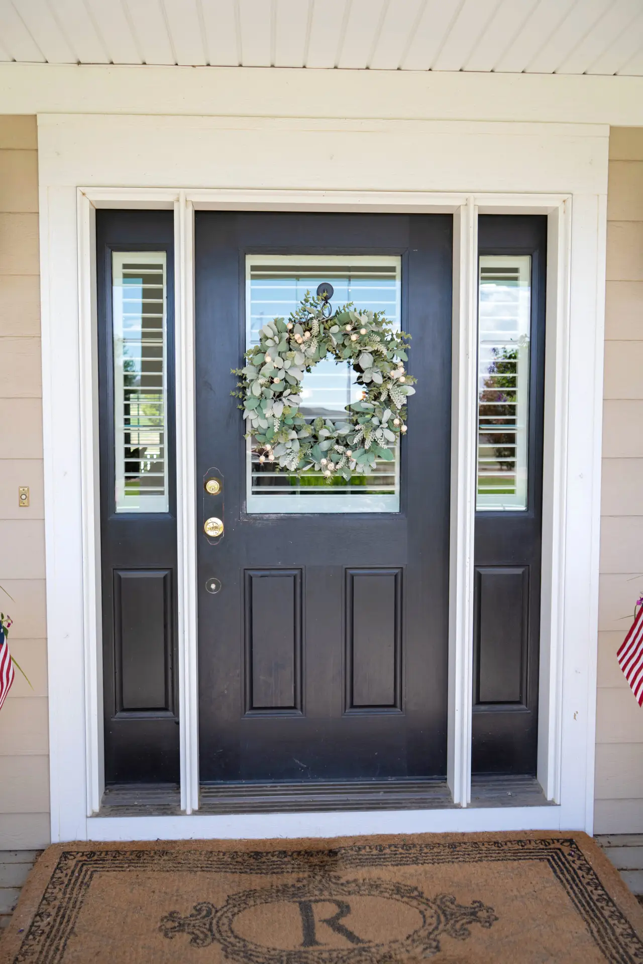A freshly refinished front entry door transforms the home's curb appeal with a rich, durable finish professionally restored by Zenith Paint and Finish.